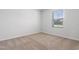 Bright bedroom with neutral carpet, large window, and fresh white walls at 1013 Kinness Dr., Conway, SC 29527
