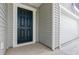 Close-up of a dark front door with sidelights, next to the garage entrance at 1013 Kinness Dr., Conway, SC 29527