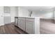 Bright, open kitchen with stainless steel dishwasher, gray cabinetry, and a view to the living area at 1013 Kinness Dr., Conway, SC 29527