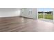 Sunny living room showcasing hardwood floors, natural light, and views of the community at 1013 Kinness Dr., Conway, SC 29527