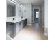 Bathroom showcasing a double vanity, granite counters, updated fixtures, and tile flooring at 1031 Snowberry Dr., Longs, SC 29568