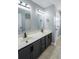 Well-lit bathroom with dual sinks and gray cabinets at 1031 Snowberry Dr., Longs, SC 29568