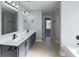 Bathroom featuring double vanity with undermount sinks, tile flooring, and a separate shower area at 1031 Snowberry Dr., Longs, SC 29568