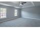 A primary bedroom with a tray ceiling and large windows at 1031 Snowberry Dr., Longs, SC 29568