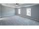 Spacious bedroom with tray ceilings, soft carpet, and natural light from two windows at 1031 Snowberry Dr., Longs, SC 29568