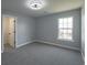Bedroom featuring soft carpeting, light gray walls, a window, and a walk-in closet at 1031 Snowberry Dr., Longs, SC 29568