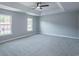 A primary bedroom with a tray ceiling and large windows at 1031 Snowberry Dr., Longs, SC 29568