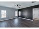 Spacious primary bedroom with an accent wall, windows, and wood floors at 1031 Snowberry Dr., Longs, SC 29568