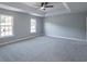 A primary bedroom with a tray ceiling and large windows at 1031 Snowberry Dr., Longs, SC 29568