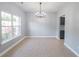Dining room with tile flooring, modern chandelier and a large window at 1031 Snowberry Dr., Longs, SC 29568