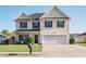 Charming two-story home featuring a well-maintained lawn and a two-car attached garage at 1031 Snowberry Dr., Longs, SC 29568