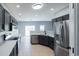 Bright kitchen features gray cabinets, stainless steel appliances, and quartz countertops at 1031 Snowberry Dr., Longs, SC 29568