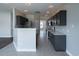 Modern kitchen with gray cabinets, stainless steel appliances, and an eat-in breakfast bar at 1031 Snowberry Dr., Longs, SC 29568