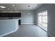 Eat-in kitchen with gray cabinets, breakfast bar, and sliding glass doors to the patio at 1031 Snowberry Dr., Longs, SC 29568