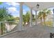 Spacious balcony featuring classic columns and wood flooring, providing an elegant outdoor living space with a scenic view at 107 Waterway Crossing Ct., Little River, SC 29566