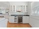 Stylish bar area includes a wine refrigerator, cabinetry, countertop and serving sink at 107 Waterway Crossing Ct., Little River, SC 29566
