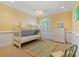Bright bedroom with bunk beds, wainscoting, and a window offering plenty of natural light at 107 Waterway Crossing Ct., Little River, SC 29566