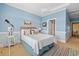 A bedroom featuring nautical decor, a comfortable bed, and an adjoining bathroom at 107 Waterway Crossing Ct., Little River, SC 29566