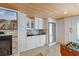 Convenient kitchenette area with white cabinets, stainless steel refrigerator, and cozy fireplace, perfect for entertaining at 107 Waterway Crossing Ct., Little River, SC 29566