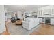 Open-concept living area features hardwood floors, modern furnishings, and open access to kitchen at 107 Waterway Crossing Ct., Little River, SC 29566