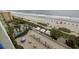 Amazing aerial view of the beach, a pool, and an expansive sun deck with lounge seating and covered tables at 1105 S Ocean Blvd. # 724, Myrtle Beach, SC 29577