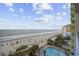Stunning aerial view of the beach and a pool, with plenty of lounge chairs and swaying palms at 1105 S Ocean Blvd. # 724, Myrtle Beach, SC 29577