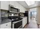 The modern kitchen features stainless steel appliances and a view of the balcony dining area at 1105 S Ocean Blvd. # 724, Myrtle Beach, SC 29577