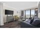 Bright living room with a large TV, comfortable seating, hardwood floors, and ocean view balcony at 1105 S Ocean Blvd. # 724, Myrtle Beach, SC 29577