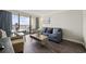 Bright living room with a large TV, comfortable seating, hardwood floors, and ocean view balcony at 1105 S Ocean Blvd. # 724, Myrtle Beach, SC 29577