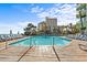 A beautiful clear blue pool with plenty of chairs for relaxing in the sun at 1105 S Ocean Blvd. # 724, Myrtle Beach, SC 29577