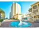 Outdoor pool area with a winding pool, lounge chairs and the condo in the background at 1207 South Ocean Blvd. # 51106, Myrtle Beach, SC 29577
