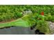 Aerial view of home on golf course and lake, surrounded by mature trees in a private setting at 1221 Tidewater Dr. # 2811, North Myrtle Beach, SC 29582