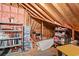 Spacious attic storage area with exposed wood beams, shelving, and insulation at 1221 Tidewater Dr. # 2811, North Myrtle Beach, SC 29582