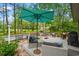 Outdoor entertaining space featuring a spacious deck with umbrella, stylish seating and a view of a natural setting at 1221 Tidewater Dr. # 2811, North Myrtle Beach, SC 29582