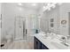 Bathroom with double vanity, white countertop, glass enclosed shower, and soaking tub by window at 1221 Tidewater Dr. # 2811, North Myrtle Beach, SC 29582