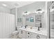 Bathroom with double vanity, updated lighting, and a walk-in shower, neutral paint at 1221 Tidewater Dr. # 2811, North Myrtle Beach, SC 29582