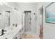 Bathroom with double sink vanity, neutral walls, and a glass-enclosed shower at 1221 Tidewater Dr. # 2811, North Myrtle Beach, SC 29582