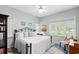 Bedroom with hardwood floors, large windows, neutral walls, an area rug, and a ceiling fan at 1221 Tidewater Dr. # 2811, North Myrtle Beach, SC 29582