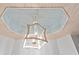 Elegant ceiling detail with a white decorative chandelier, white trim and light blue paint at 1221 Tidewater Dr. # 2811, North Myrtle Beach, SC 29582