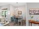 Cozy dining area with a round table, charming chandelier, and sliding door to the outside at 1221 Tidewater Dr. # 2811, North Myrtle Beach, SC 29582