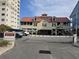 Unique coastal-style building with a red roof and parking spaces for residents at 1221 Tidewater Dr. # 2811, North Myrtle Beach, SC 29582