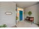 Inviting front porch with a bright blue door, a 'Welcome' sign, bench seating, and stylish decorations at 1221 Tidewater Dr. # 2811, North Myrtle Beach, SC 29582