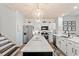 Bright kitchen featuring white cabinetry, stainless steel appliances, a marble countertop island, and modern lighting at 1221 Tidewater Dr. # 2811, North Myrtle Beach, SC 29582