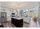 Spacious kitchen with stainless steel appliances, island with marble countertop, and open view to the living room at 1221 Tidewater Dr. # 2811, North Myrtle Beach, SC 29582