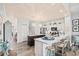 Open-concept kitchen with a marble countertop island, barstool seating, and white cabinetry flowing into the living space at 1221 Tidewater Dr. # 2811, North Myrtle Beach, SC 29582