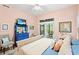 Main bedroom featuring bright walls, a ceiling fan, neutral bedding, and an outdoor view at 1221 Tidewater Dr. # 2811, North Myrtle Beach, SC 29582
