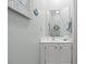 Elegant powder room with a white vanity, decorative mirror, and neutral decor at 1221 Tidewater Dr. # 2811, North Myrtle Beach, SC 29582