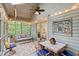 Relaxing screened porch with a swing, dining table, and inviting outdoor ambiance at 1221 Tidewater Dr. # 2811, North Myrtle Beach, SC 29582