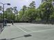 Well maintained community tennis court surrounded by lush greenery offering a recreational amenity for residents at 1221 Tidewater Dr. # 2811, North Myrtle Beach, SC 29582