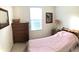 Cozy bedroom with a pink bedspread, bedside table, and lots of natural light at 131 Goodale Dr., Longs, SC 29568